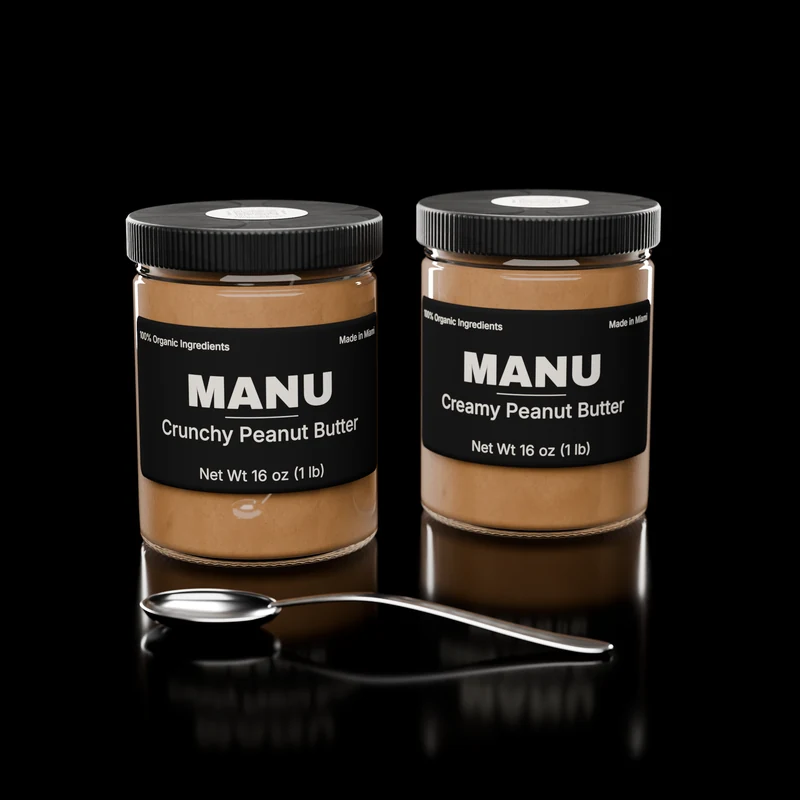 A crunchy and a creamy jar of MANU peanut butter side by side on black.