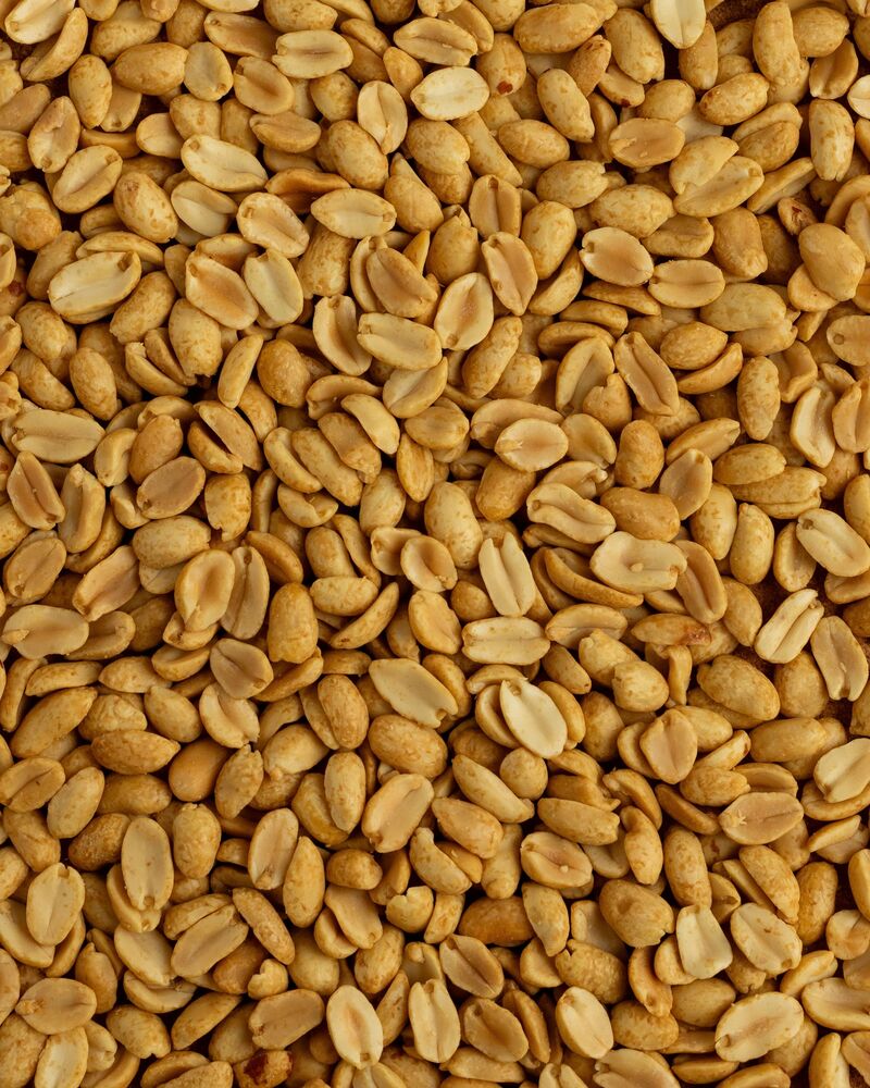 Roasted peanut kernels filling the frame.
