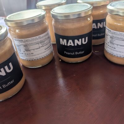 MANU peanut butter jars on a wooden table