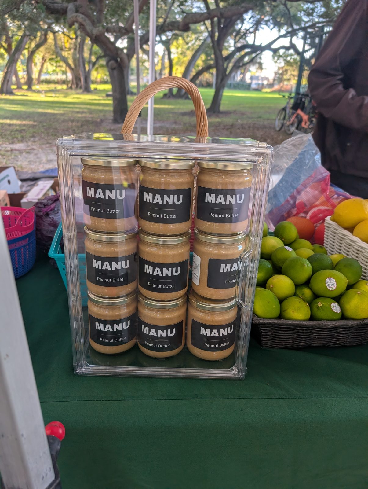 A crate of MANU jars on the stall at an outdoor farmers market